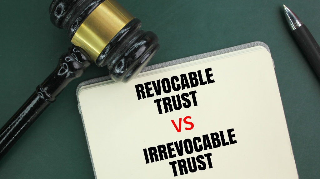 Judge's gavel, pen and book with the words Irrevocable Trust vs Revocable Trust